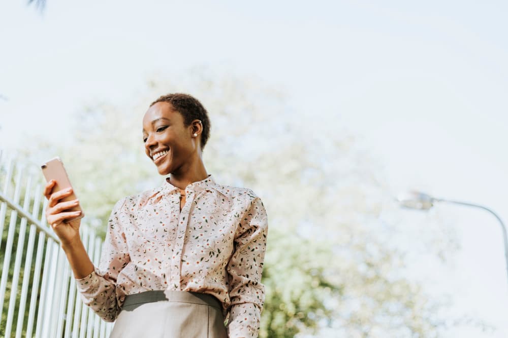 Woman using M-Pesa Tracker on her phone